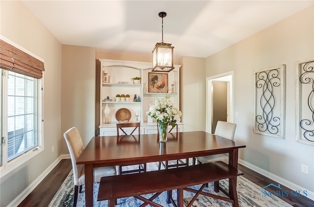 dining area with a healthy amount of sunlight and dark hardwood / wood-style floors