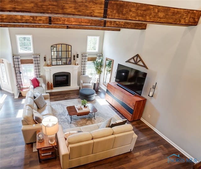 living room featuring dark wood-type flooring, a high ceiling, and beam ceiling