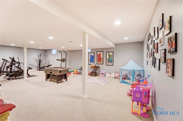 recreation room featuring light carpet