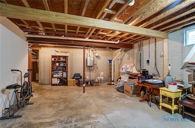 basement with brick wall and tankless water heater