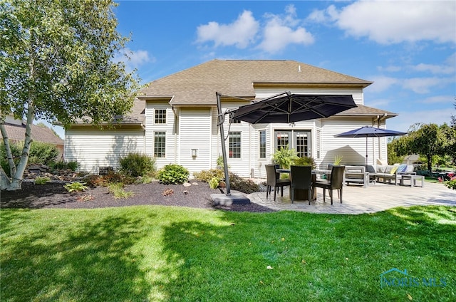 back of house with a lawn and a patio area