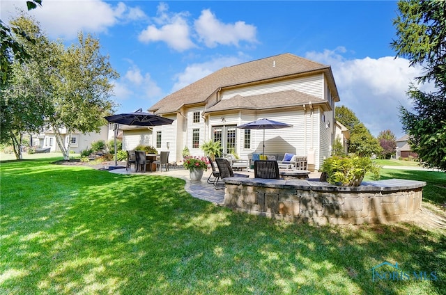 rear view of house with a patio area and a yard