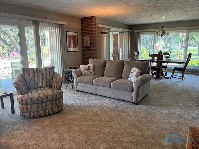 carpeted living room with a textured ceiling and a notable chandelier