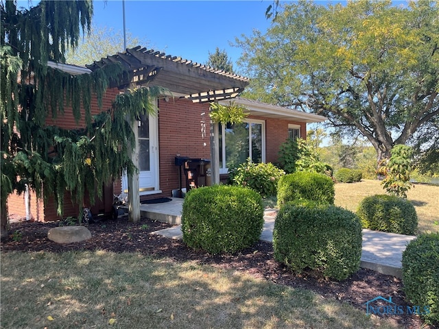 view of side of property featuring a pergola