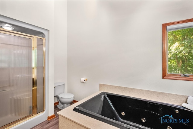 bathroom with toilet, hardwood / wood-style floors, and independent shower and bath