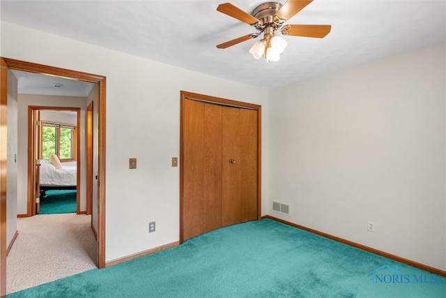 unfurnished bedroom with a closet, ceiling fan, and light carpet