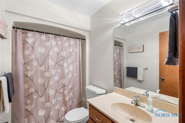 bathroom featuring vanity, a shower with curtain, and toilet