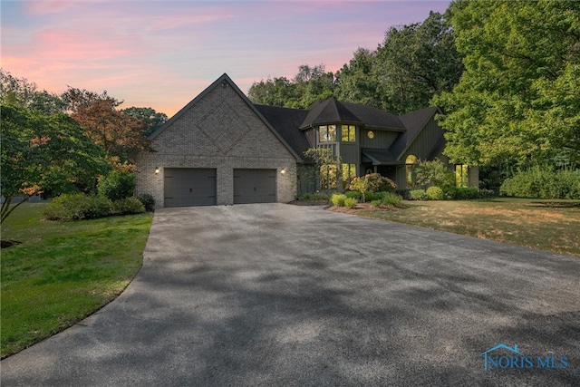 view of front of property featuring a yard and a garage