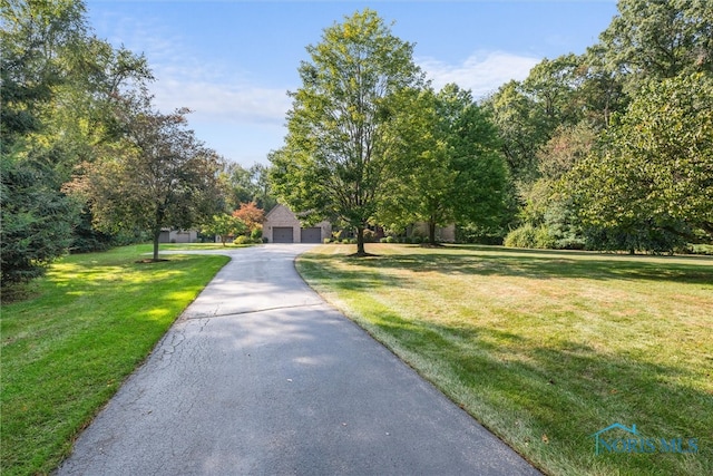 view of property's community with a lawn