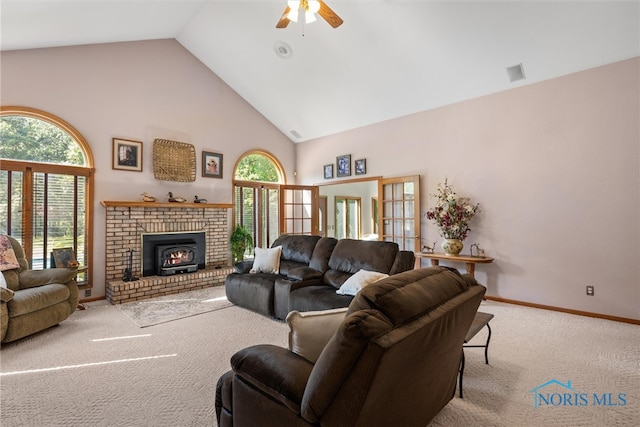 living room with ceiling fan, light colored carpet, high vaulted ceiling, and plenty of natural light