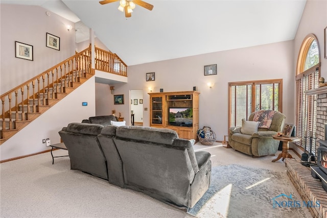 living room with ceiling fan, high vaulted ceiling, and carpet floors