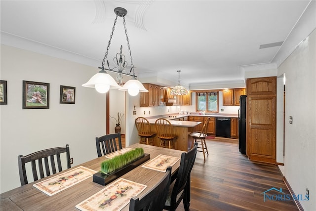 dining room with ornamental molding, sink, and dark hardwood / wood-style flooring