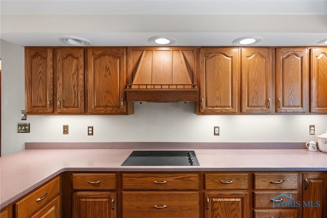 kitchen with custom range hood and black electric stovetop