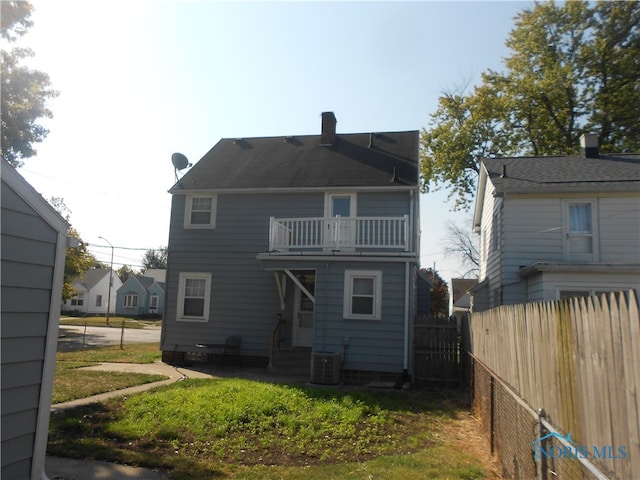 back of house featuring a balcony and central air condition unit