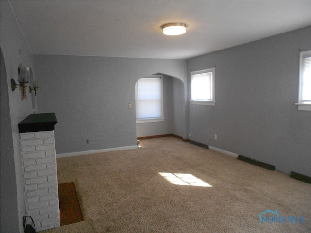 unfurnished room featuring light carpet