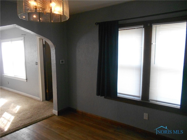 empty room with dark wood-type flooring