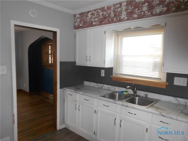 kitchen with ornamental molding, white cabinetry, dark wood-type flooring, and sink