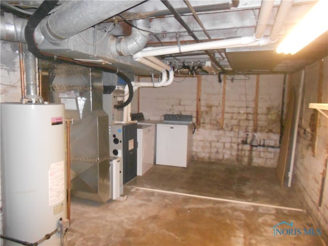 basement featuring water heater and washer / dryer