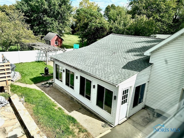 exterior space with a storage shed, a yard, and a patio area