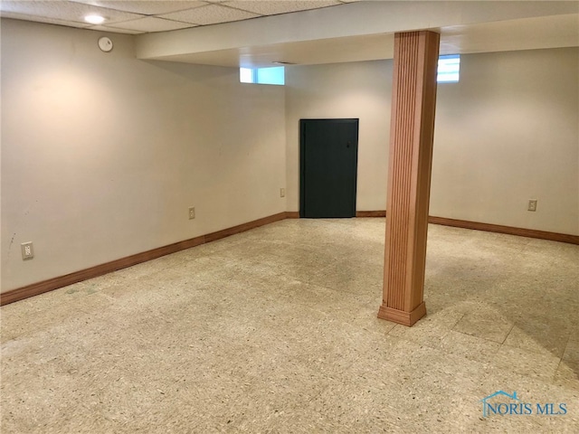 basement featuring a drop ceiling