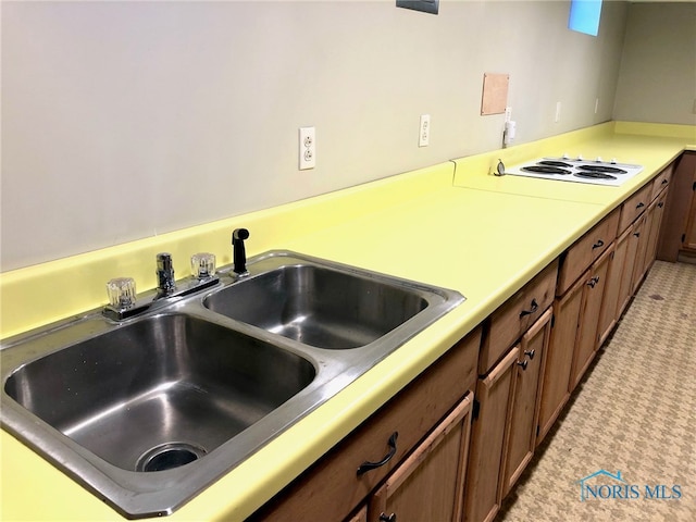 kitchen featuring white cooktop and sink