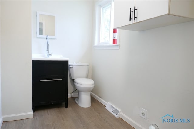 bathroom featuring hardwood / wood-style flooring, vanity, and toilet