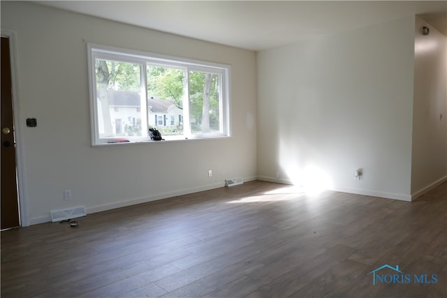 unfurnished room featuring dark hardwood / wood-style flooring