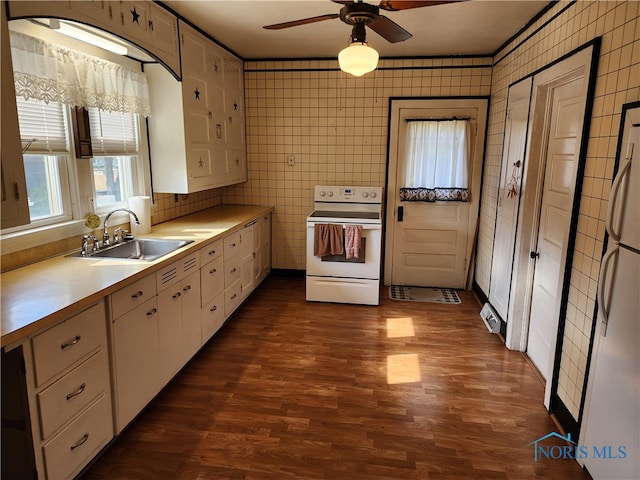 kitchen featuring white appliances, ceiling fan, white cabinetry, and sink