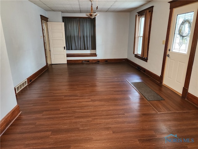 foyer entrance featuring dark hardwood / wood-style floors and a paneled ceiling