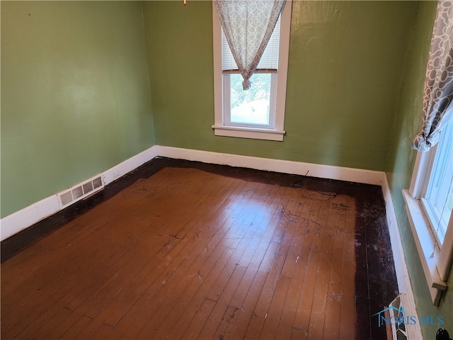 empty room with hardwood / wood-style floors