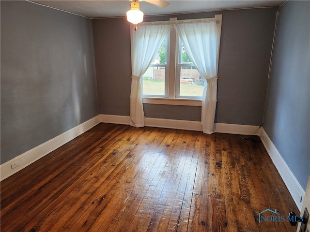 empty room featuring ceiling fan and dark hardwood / wood-style floors