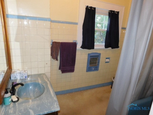 bathroom with tile walls and vanity