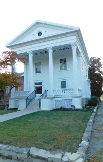 view of front of home with a front yard and a porch