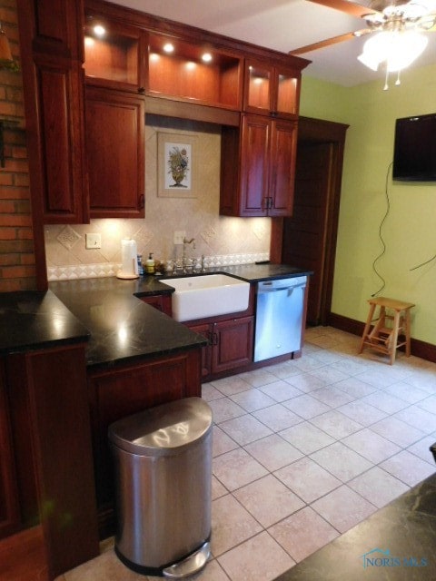 kitchen with ceiling fan, dishwasher, sink, and decorative backsplash