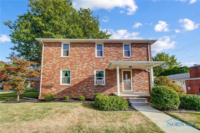 view of property featuring a front lawn