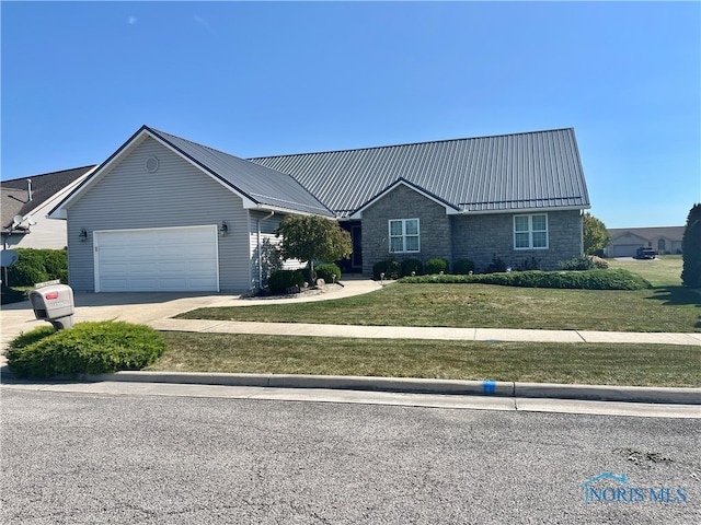 view of front of property with a front yard and a garage