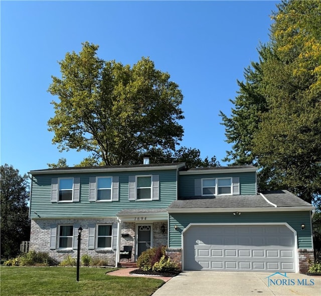 view of front of house with a garage and a front yard