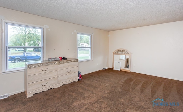 carpeted bedroom with a textured ceiling