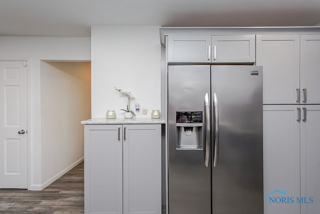 kitchen featuring stainless steel refrigerator with ice dispenser and dark hardwood / wood-style flooring