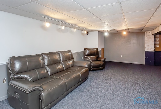 carpeted cinema room featuring a paneled ceiling and rail lighting