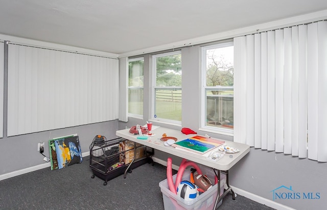 recreation room featuring dark carpet