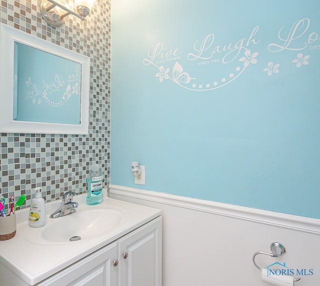 bathroom featuring decorative backsplash and vanity