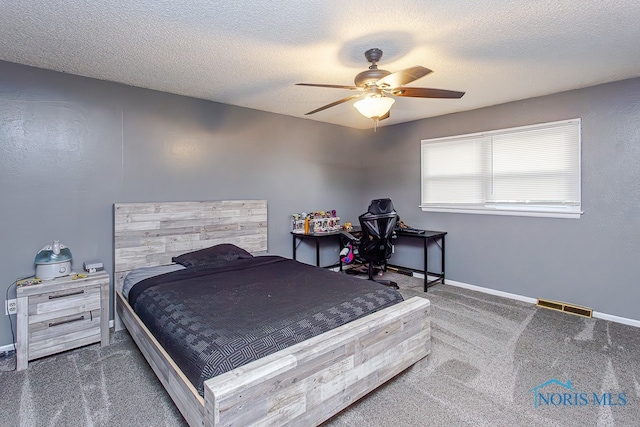 carpeted bedroom featuring ceiling fan and a textured ceiling