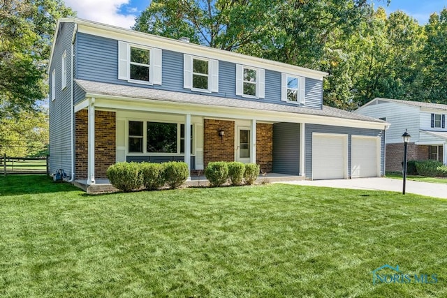 front of property with a front yard, a garage, and a porch