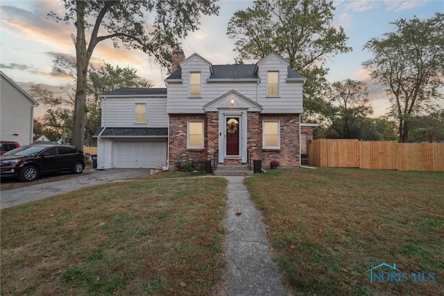 view of front facade with a garage and a yard