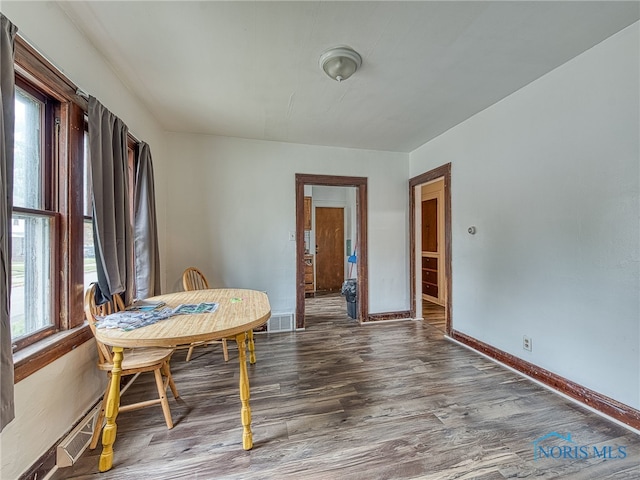 dining room with dark hardwood / wood-style flooring