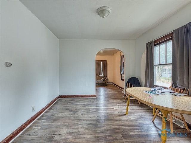 dining room with dark hardwood / wood-style flooring