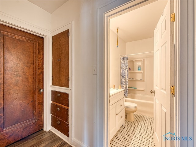 full bathroom with vanity, toilet, hardwood / wood-style flooring, and shower / bath combo