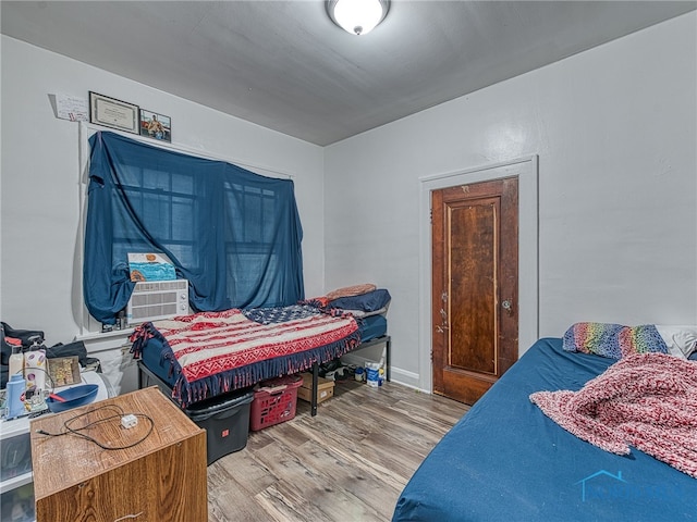 bedroom featuring light hardwood / wood-style flooring and cooling unit