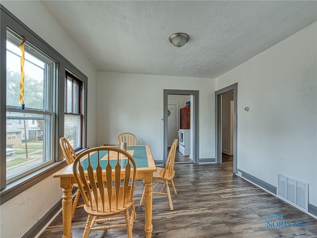 dining area with washer / clothes dryer, a textured ceiling, and dark hardwood / wood-style floors